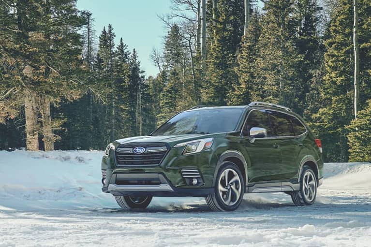  2022 Subaru Forester parked by a snowbank in a forest