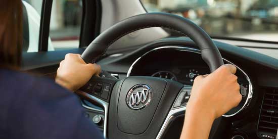 View of hands holding steering wheel