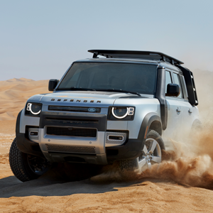 land rover defender driving in sand dunes