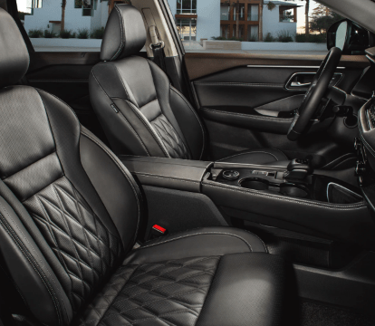 Side view of the black leather seats inside a 2022 Nissan Rogue